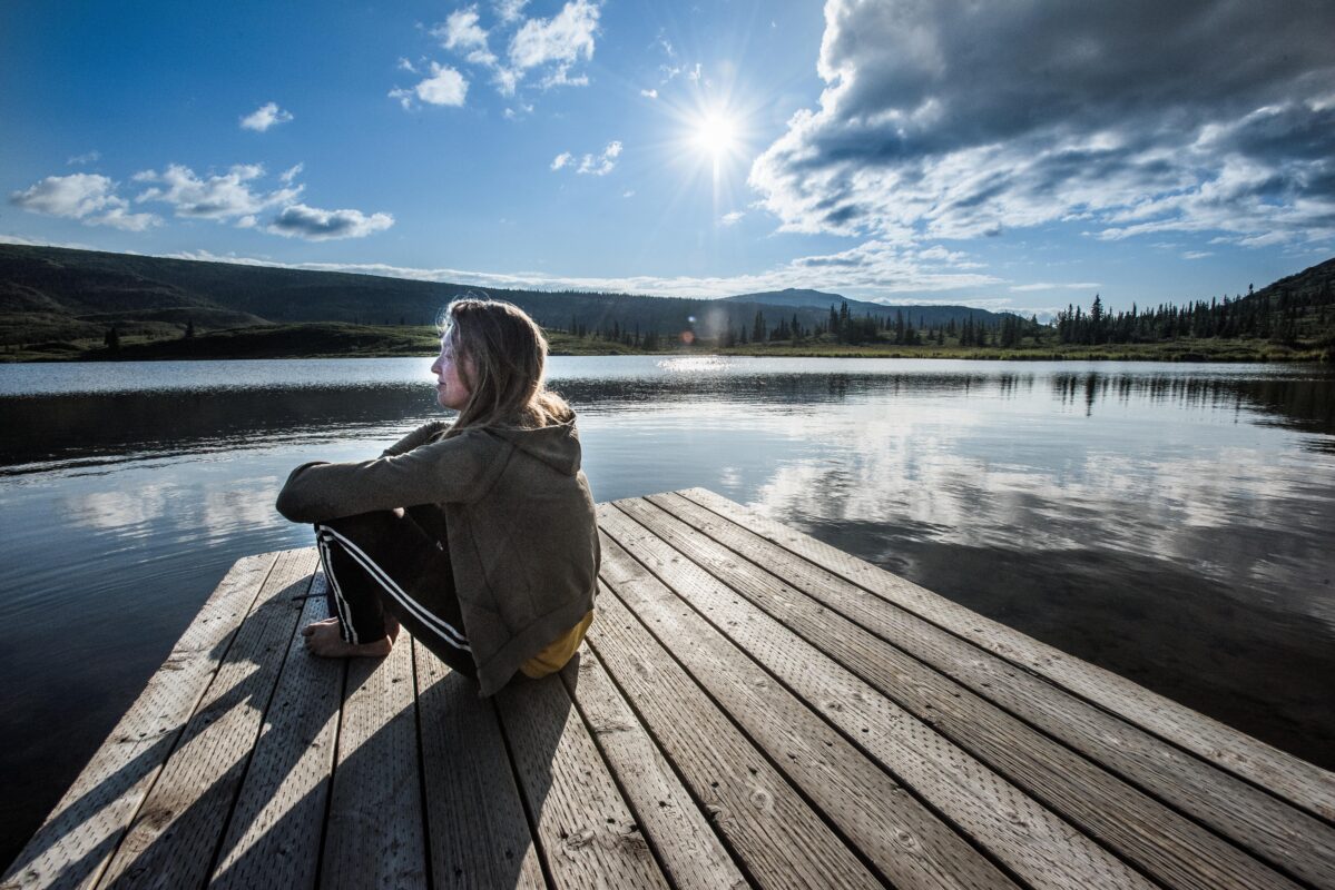 Person enjoying mushroom chocolate in peaceful nature setting